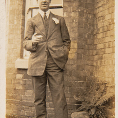 Wedding Guest standing outside house