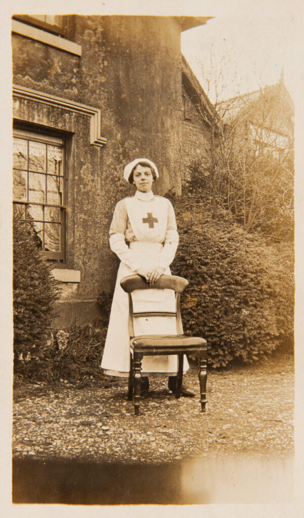 Nurse standing by chair outside