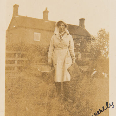 Milk Maid standing outside farm