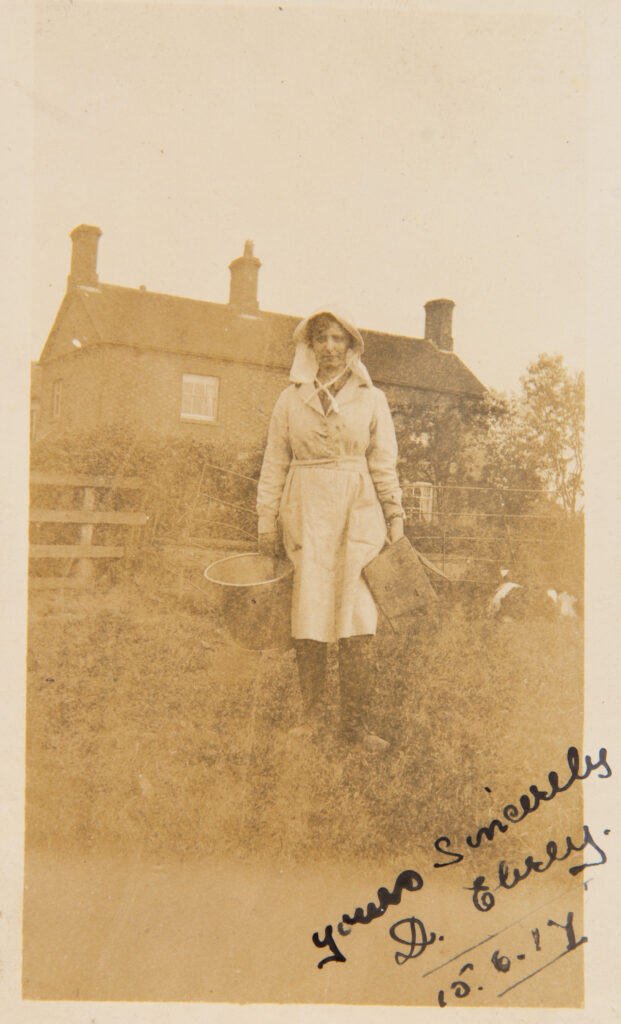 Milk Maid standing outside farm