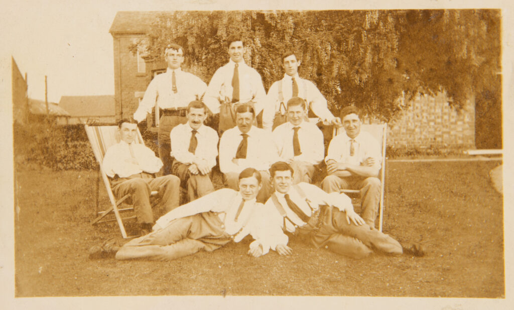 Group of men posing on the lawn