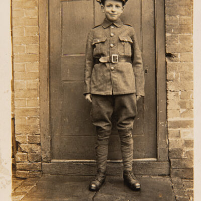 Boy Soldier standing in doorway