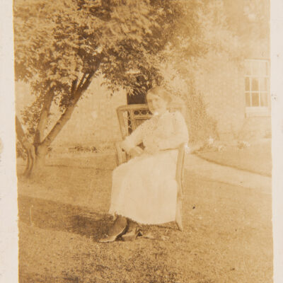 Lady sitting on chair outside