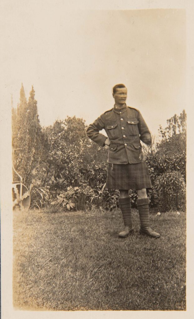 Soldier in kilt standing in garden