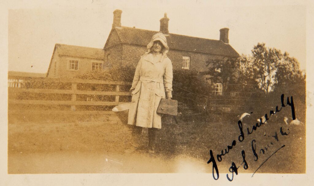 Milk Maid standing outside farm
